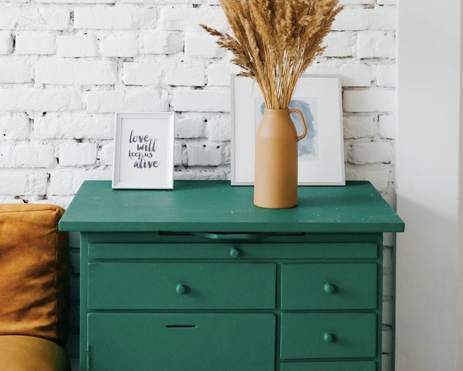 Image of green drawers with a vase on top